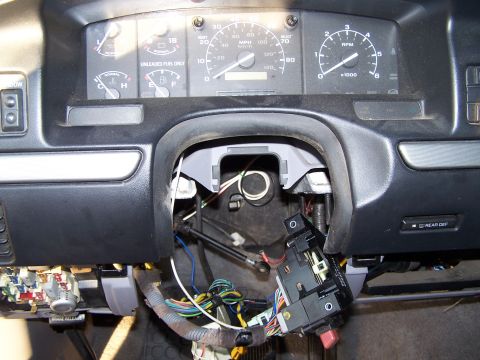 1995 Ford Bronco - Dashboard interior of a 1995 Ford Bronco with steering column and wiring exposed for repair.