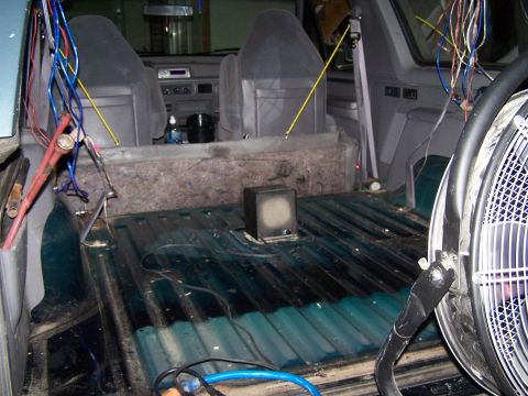 1995 Ford Bronco - The rear interior of a 1995 Ford Bronco is visible, with many wires and a small speaker installed.