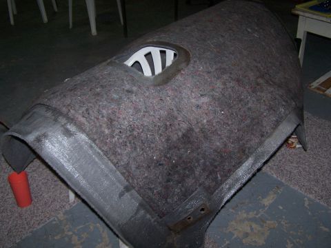1995 Ford Bronco - Interior trim panel covered in carpet material with a white plastic vent opening.