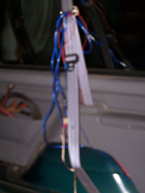 1995 Ford Bronco - Close-up of tangled wiring and a seat inside a vehicle.