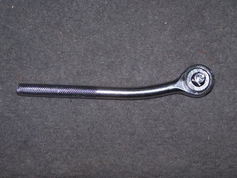 1995 Ford Bronco - A chrome ratchet wrench is shown against a dark, textured background.