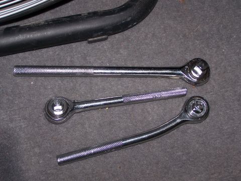 1995 Ford Bronco - A collection of ratchet wrenches, with a black pipe element in the background.