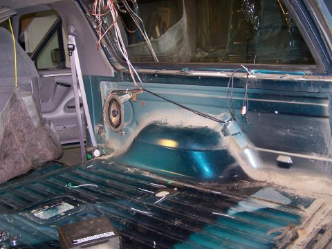1995 Ford Bronco - The interior of a vehicle is shown with exposed wiring and a speaker, indicating a work in progress or modification.