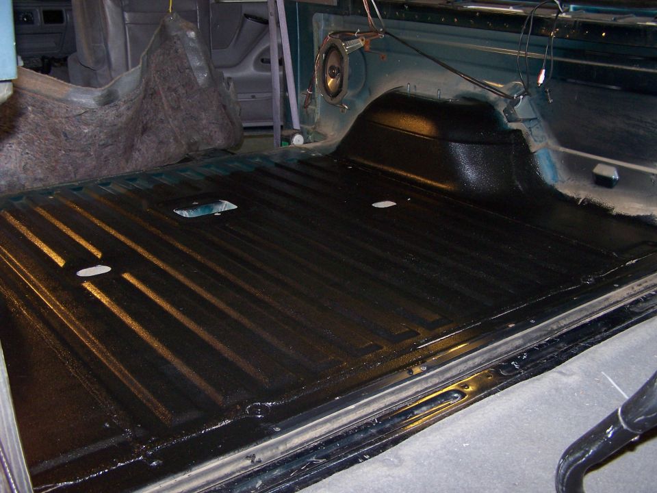 black bed liner with ribbed texture inside a vehicle