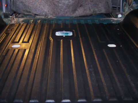 1995 Ford Bronco - The ribbed bed liner of a vehicle is shown, with a light fixture visible in the center.