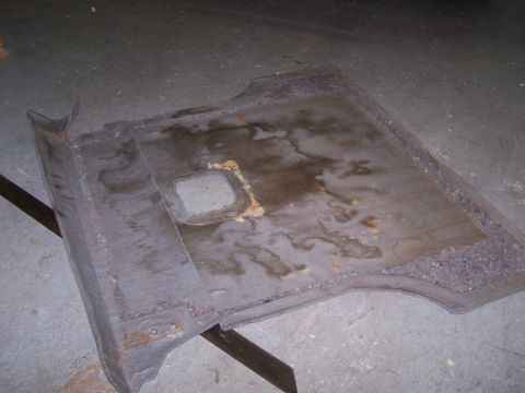 1995 Ford Bronco - This carpeted cargo area liner appears to be from a vehicle, possibly a Ford Bronco, but is too damaged to confirm the year or model.