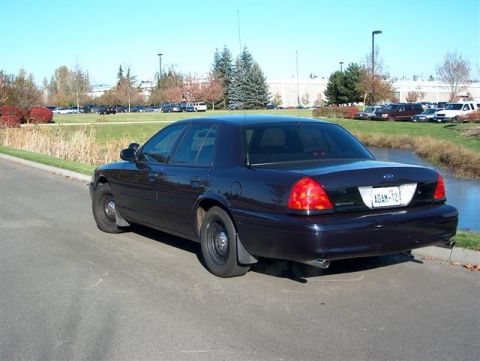 2001 Ford Crown Victoria - This dark blue 2001 Ford Crown Victoria sedan is viewed from the rear 3/4 angle.