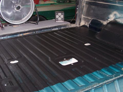 1995 Ford Bronco - Truck bed liner application in progress, showing the ribbed texture and a fan for drying.