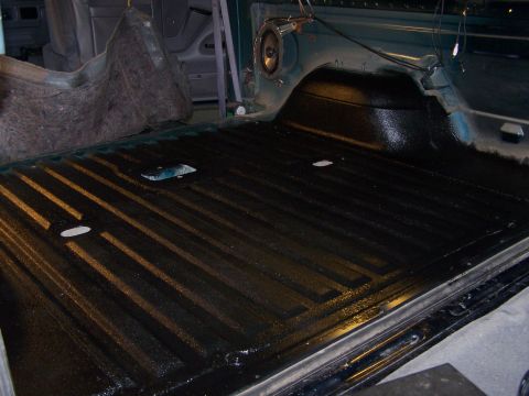 1995 Ford Bronco - The interior of a 1995 Ford Bronco shows a freshly coated bed liner with a ribbed texture.