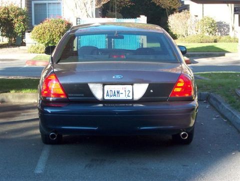 2001 Ford Crown Victoria - The rear of a 2001 Ford Crown Victoria is shown, its distinctive taillights and license plate.