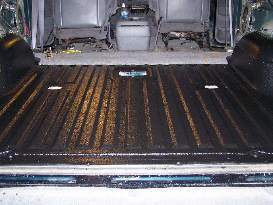 1995 Ford Bronco interior bed liner with textured black coating and gray seats