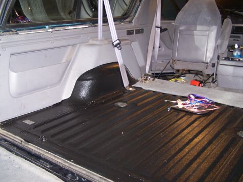 1995 Ford Bronco - Interior of a 1995 Ford Bronco, showing the cargo area with black bed liner.