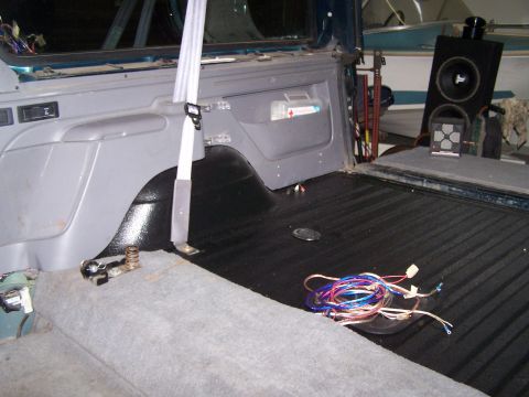 1995 Ford Bronco - Interior view of a 1995 Ford Bronco's cargo area, showing the bed liner and audio components.
