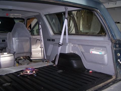 1995 Ford Bronco - Interior of a 1995 Ford Bronco, focusing on the rear seating and cargo space.