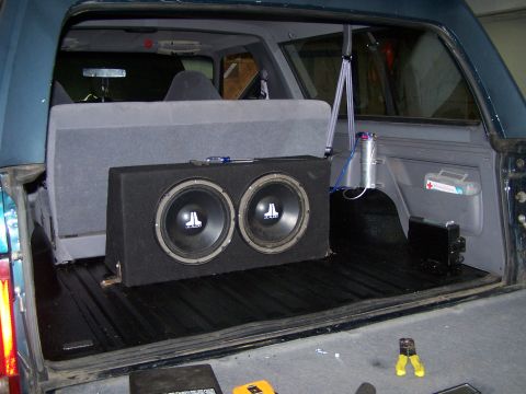 1995 Ford Bronco - Dual JL Audio subwoofers are installed in a box within the cargo area of this SUV.