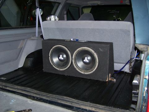 1995 Ford Bronco - Dual subwoofer box installed in the cargo area of a vehicle, behind the rear seats.
