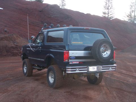 1995 Ford Bronco - Rear view of a lifted 1995 Ford Bronco with a spare tire mounted externally.