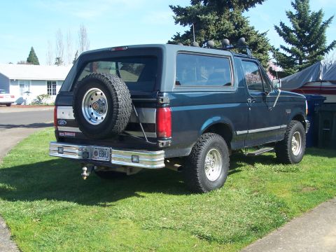 1995 Ford Bronco - This lifted SUV has a spare tire on the back and a roof rack, suggesting off-road capability.