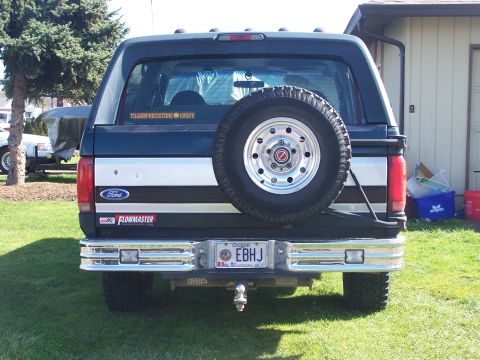 1995 Ford Bronco - Rear view of a Ford Bronco showing its spare tire and aftermarket stickers.