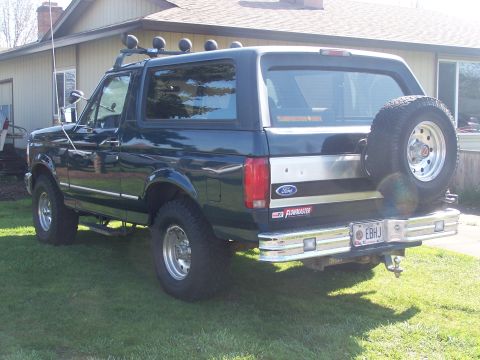 1995 Ford Bronco - This Ford Bronco features a roof rack with lights and a spare tire mounted on the rear tailgate.
