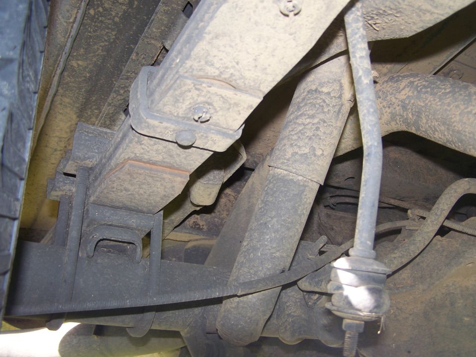 Rear suspension leaf springs and shock absorber on a lifted vehicle