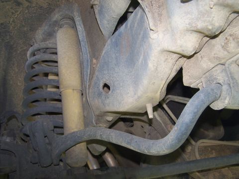 1995 Ford Bronco - Close-up of the undercarriage, showing suspension parts and a sway bar, with no visible year identification.