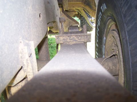 1995 Ford Bronco - This photo shows a close-up view of a vehicle's suspension system, focusing on the leaf springs and a tire.