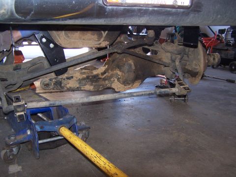 1995 Ford Bronco - Underbody view of a 1995 Ford Bronco's rear axle and suspension system during maintenance.