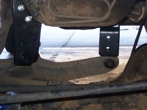 1995 Ford Bronco - Close-up view of aftermarket suspension lift components installed on a vehicle's rear axle.