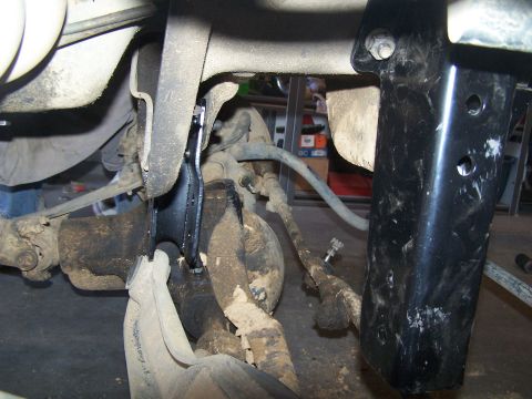 1995 Ford Bronco - Underbody view of suspension components, likely from a lifted vehicle, showing modifications to the frame and axle.