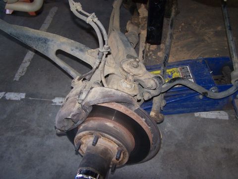 1995 Ford Bronco - Front suspension component, likely from a truck or SUV, with brake rotor and hub visible.