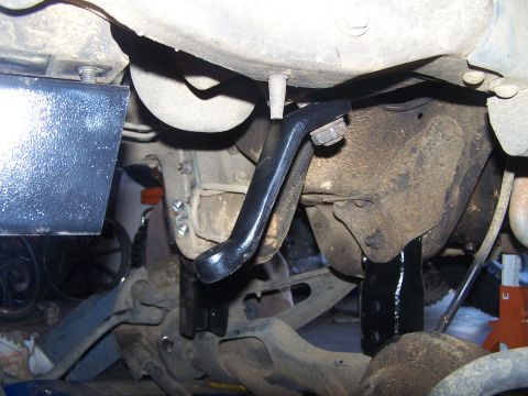 1995 Ford Bronco - Close-up view of aftermarket suspension components installed on a vehicle's undercarriage, with a website logo visible.
