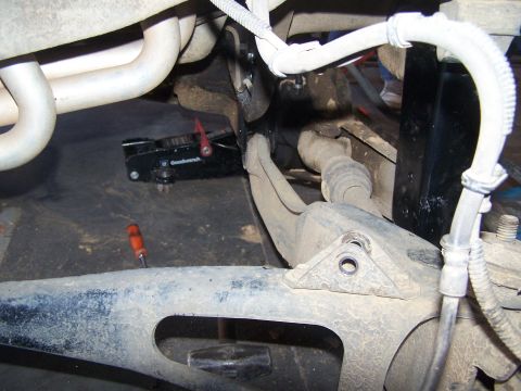 1995 Ford Bronco - Close-up view of a vehicle's suspension components and exhaust system.