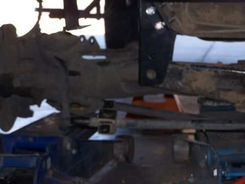 1995 Ford Bronco - This image shows the underside of a vehicle, focusing on suspension parts and a lift kit installation.