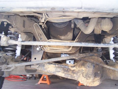 1995 Ford Bronco - The underside of a vehicle is shown, highlighting modifications for a lift kit.