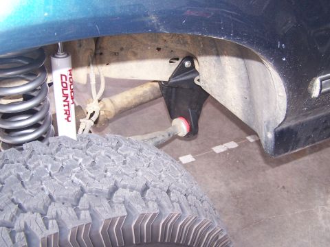 1995 Ford Bronco - Close-up of a vehicle's suspension system, showing a shock and linkage.