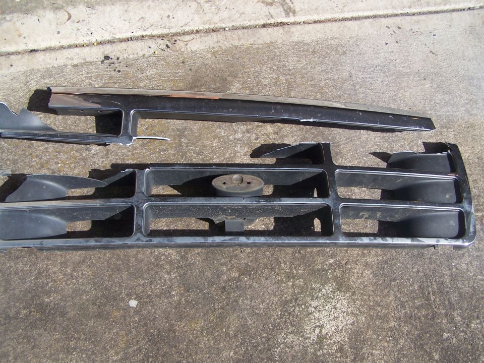 1995 Ford Bronco grille with chrome trim and oval emblem mount