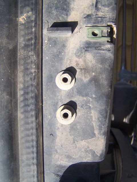 1995 Ford Bronco - Detail of vehicle body panel with mounting hardware, including bolts and a clip.