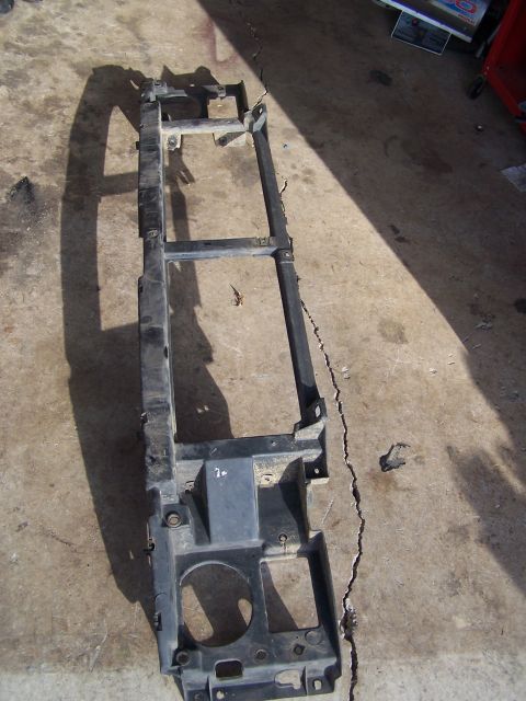 1995 Ford Bronco - Radiator support frame shown from above, resting on a concrete surface.
