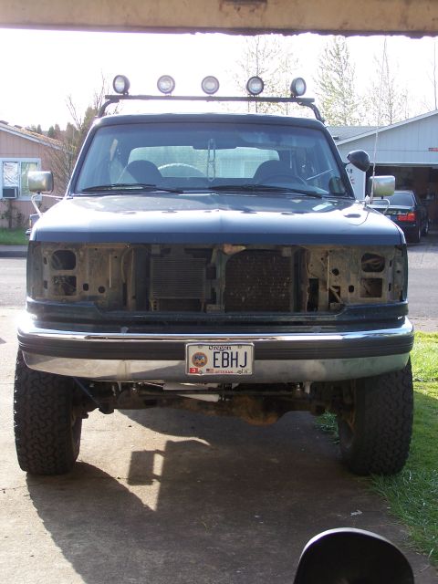 1995 Ford Bronco - This Ford Bronco is missing its grille and headlights, showing the radiator and front end components.