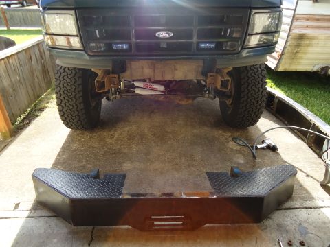 1995 Ford Bronco - The front of a 1995 Ford Bronco is shown with a custom diamond plate bumper placed in front of it.