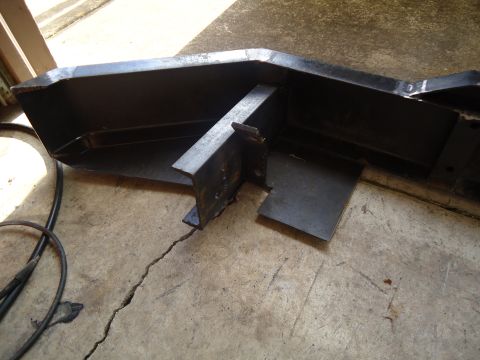 1995 Ford Bronco - A custom bumper part is shown on a cracked concrete surface, with welding cables nearby.