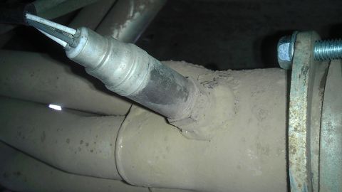 1995 Ford Bronco - An oxygen sensor is shown attached to the exhaust system of a vehicle.