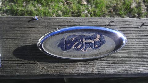 1995 Ford Bronco - A close-up of a Ford oval badge, showing wear and tear on its blue insert.