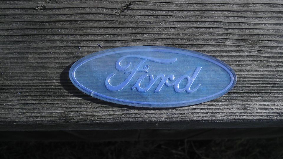 Blue Ford oval emblem on wooden planks