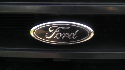 1995 Ford Bronco - The iconic Ford oval emblem is centered on a dark grille.
