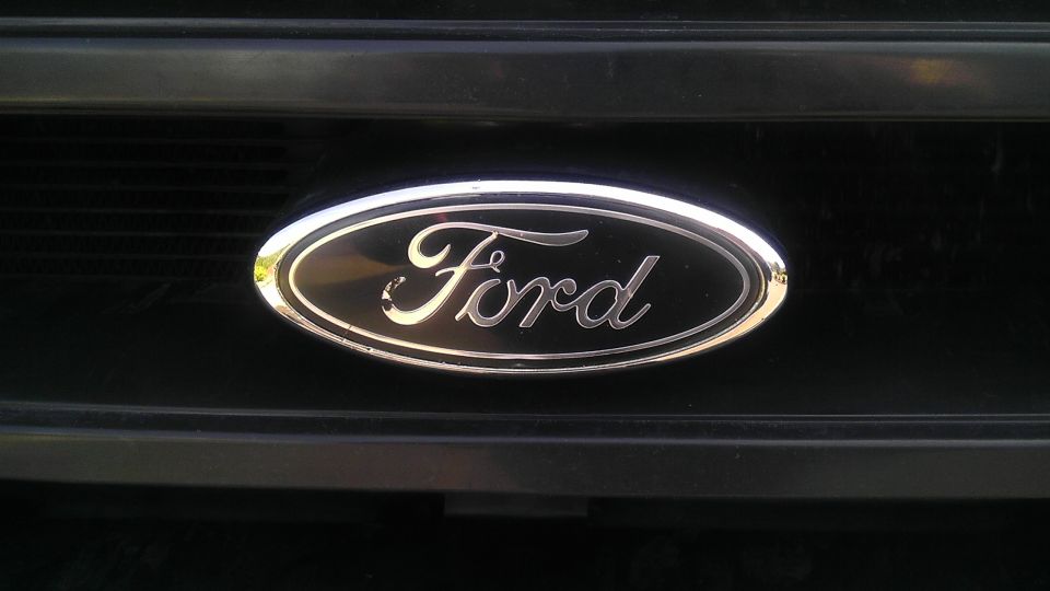 Close-up of Ford emblem on a black grille