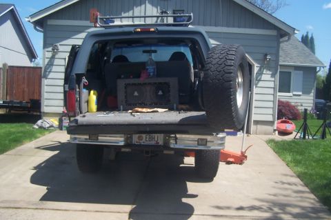 1995 Ford Bronco - This lifted SUV features a spare tire mounted to the side and a custom audio setup visible in the cargo area.