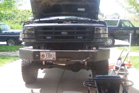 1995 Ford Bronco - This 1995 Ford Bronco features an aftermarket bumper and its hood is open, revealing the engine bay.
