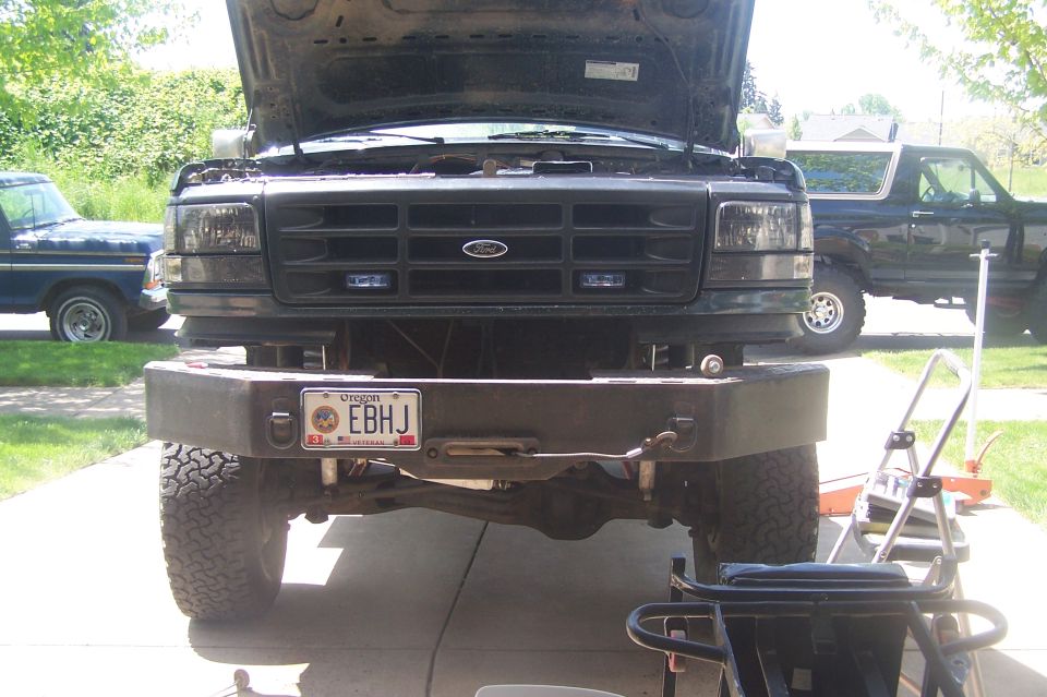 Front view of 1995 Ford Bronco with aftermarket bumper and hood open
